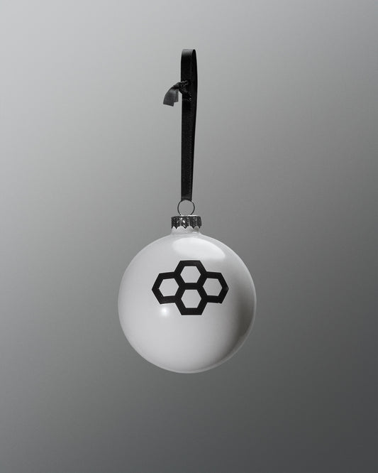 White spherical pendant with black geometric design on a gray background