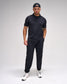 Man wearing a black outfit with a cap on a white background