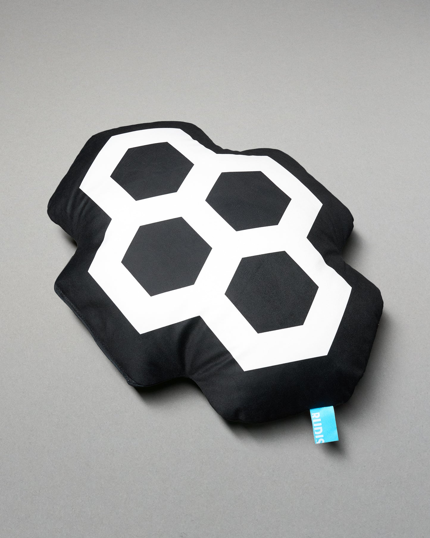 Black pillow with white geometric design on a gray background