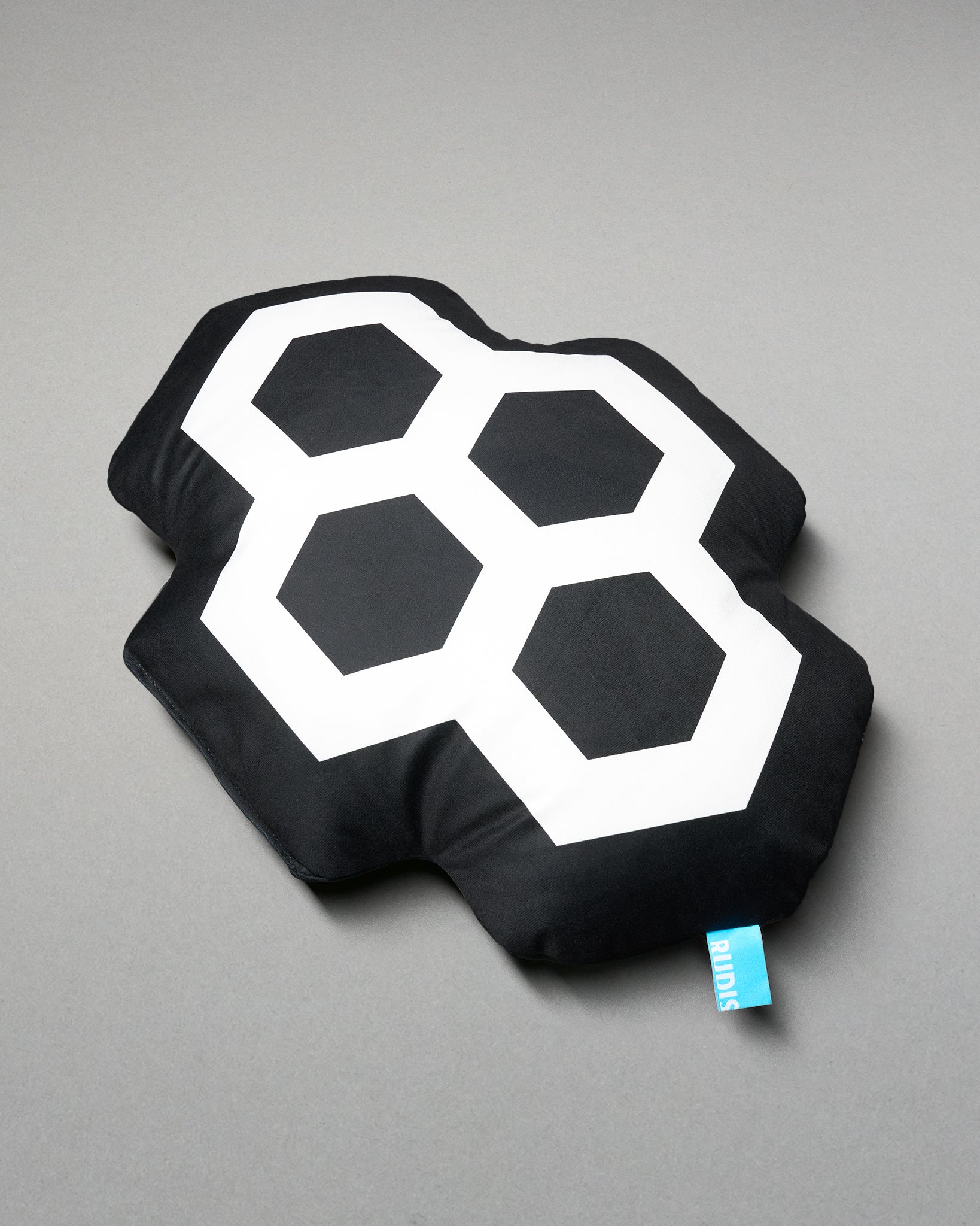 Black pillow with white geometric design on a gray background