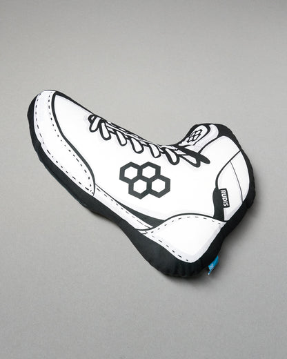 White shoe-shaped pillow with black accents on a gray background