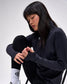 Person wearing a black outfit with a logo on a white background