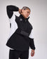 Person wearing a black and white outfit with 'RUDIS' branding on a gray background