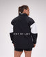 Person wearing a black and white jacket with 'A Way of Life' text on the back, on a plain background.