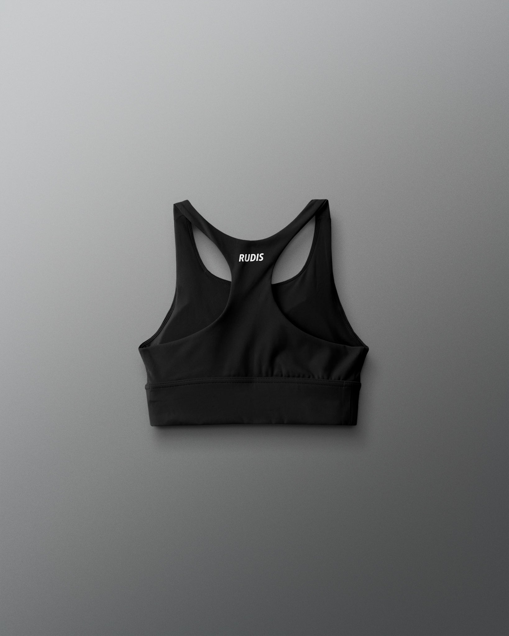 Black sports bra with brand logo on a gray background