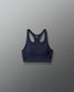 Navy blue sports bra on a gray background