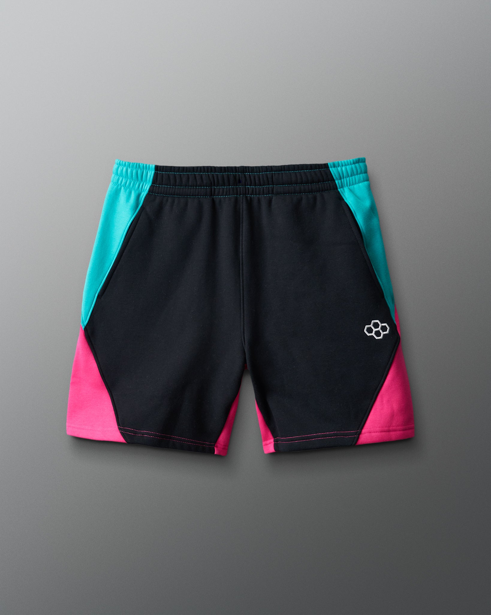 Black shorts with teal and pink sides on a gray background