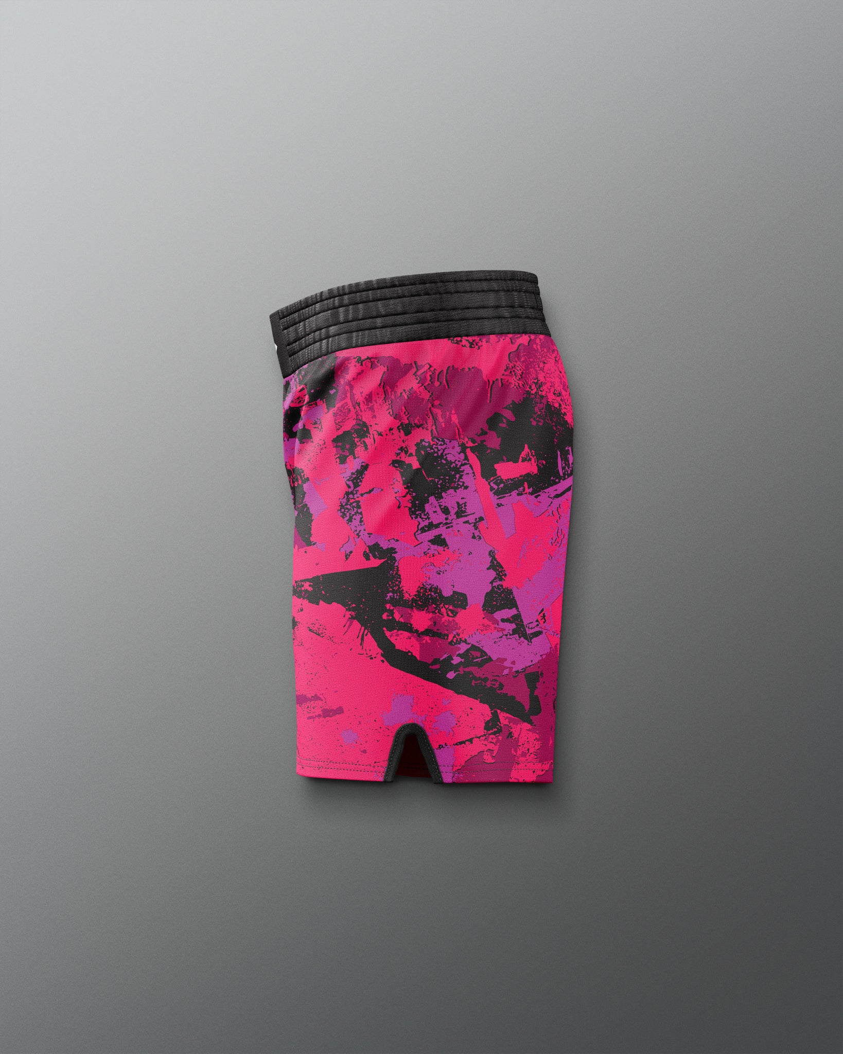 Pink and black patterned shorts on a gray background