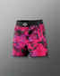 Pink and black patterned shorts with a brand logo on a gray background