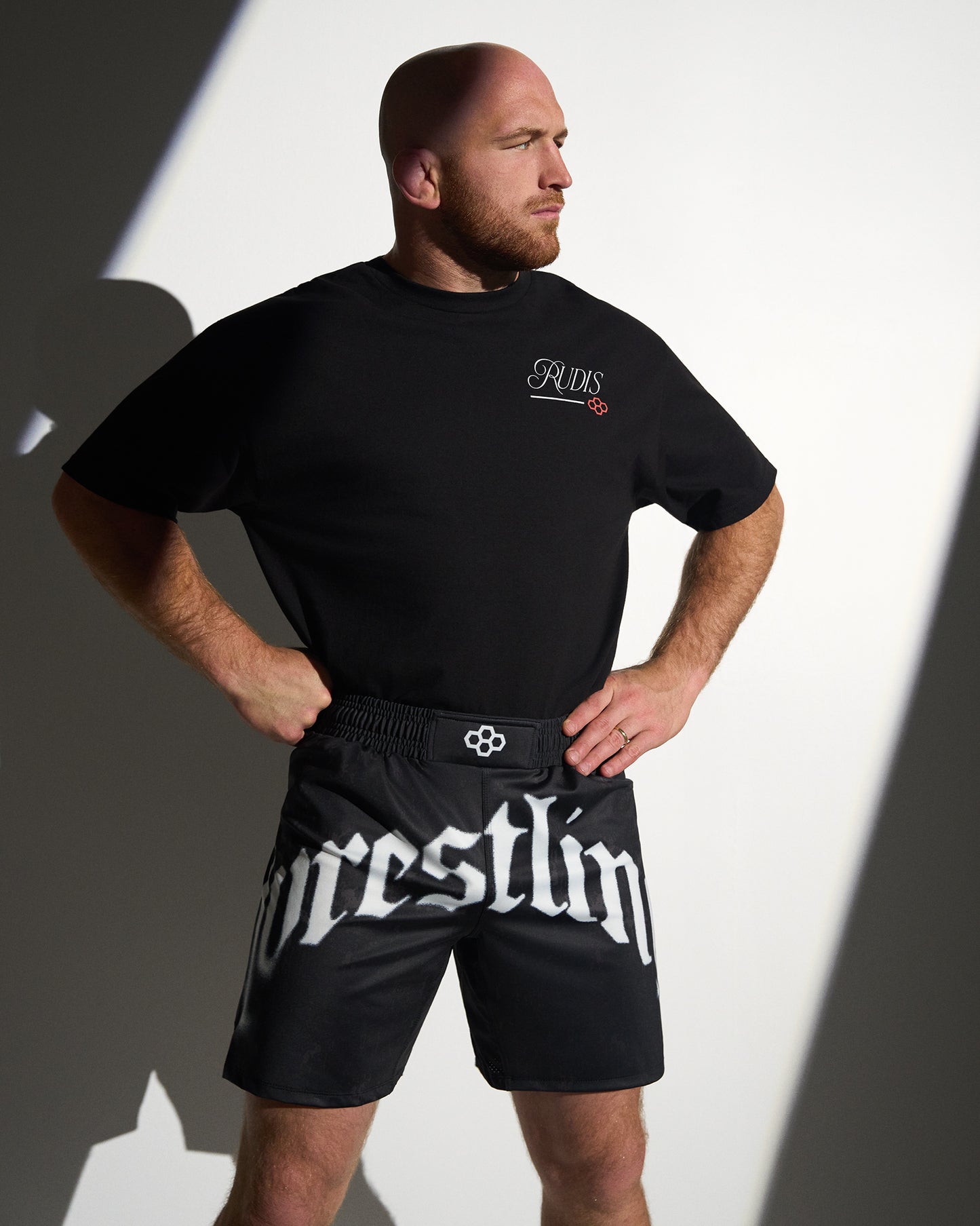 RUDIS Gothic Wrestling Sublimated Shorts in black with bold gothic "Wrestling" graphics, lightweight moisture-wicking fabric, and an athletic fit designed for wrestling training and everyday performance.