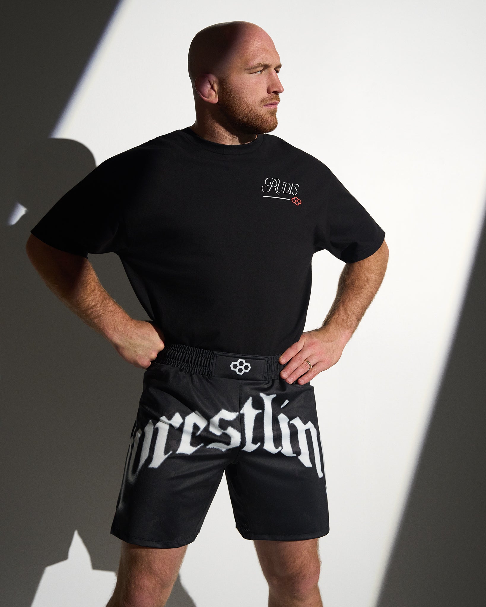 RUDIS Gothic Wrestling Sublimated Shorts in black with bold gothic "Wrestling" graphics, lightweight moisture-wicking fabric, and an athletic fit designed for wrestling training and everyday performance.