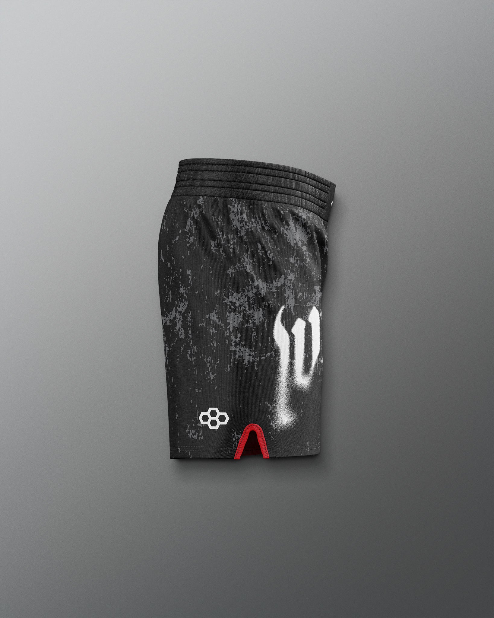 Black athletic shorts with white logo and red accents on a gray background