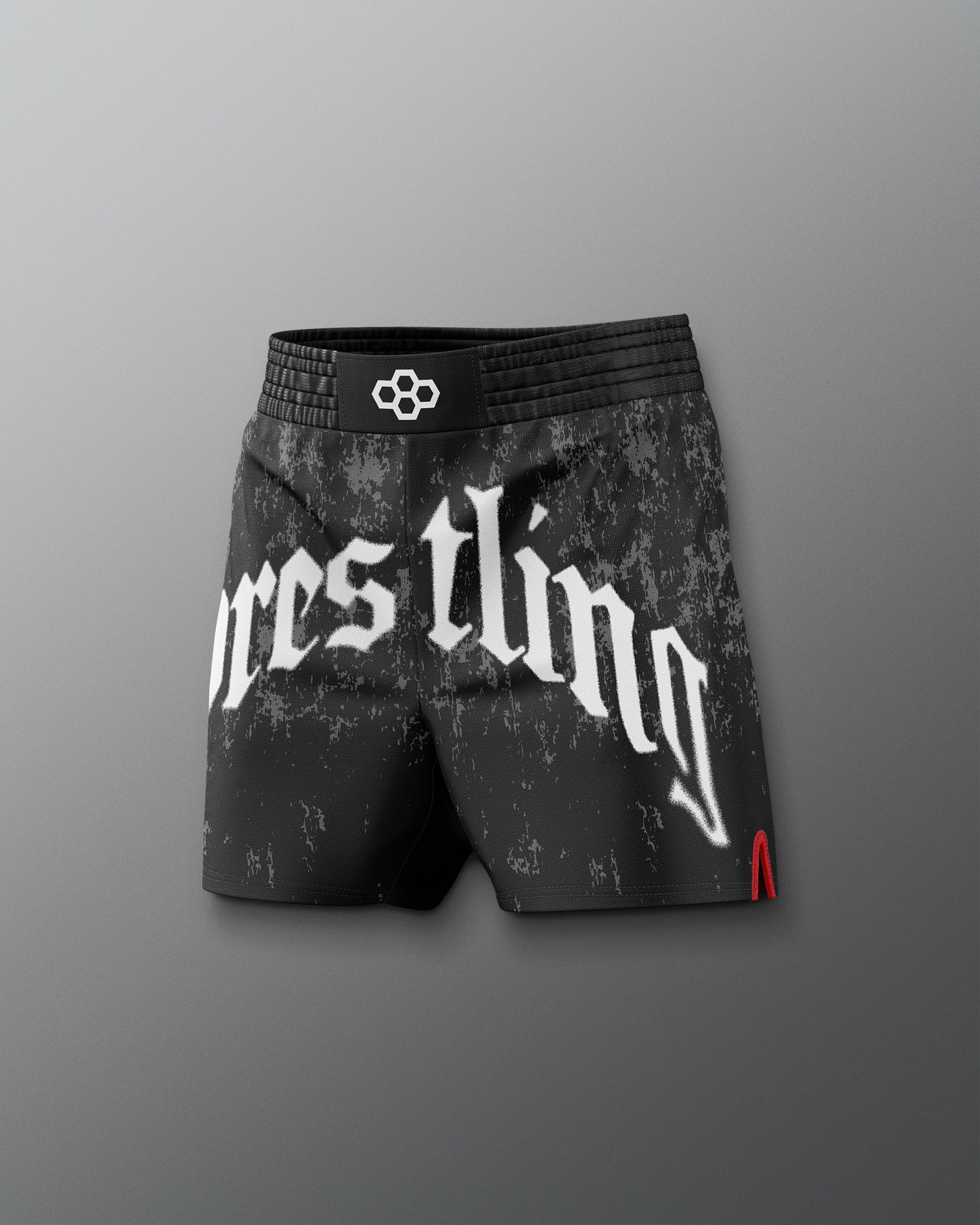 Black wrestling shorts with white text on a gray background