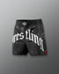 Black wrestling shorts with white text on a gray background