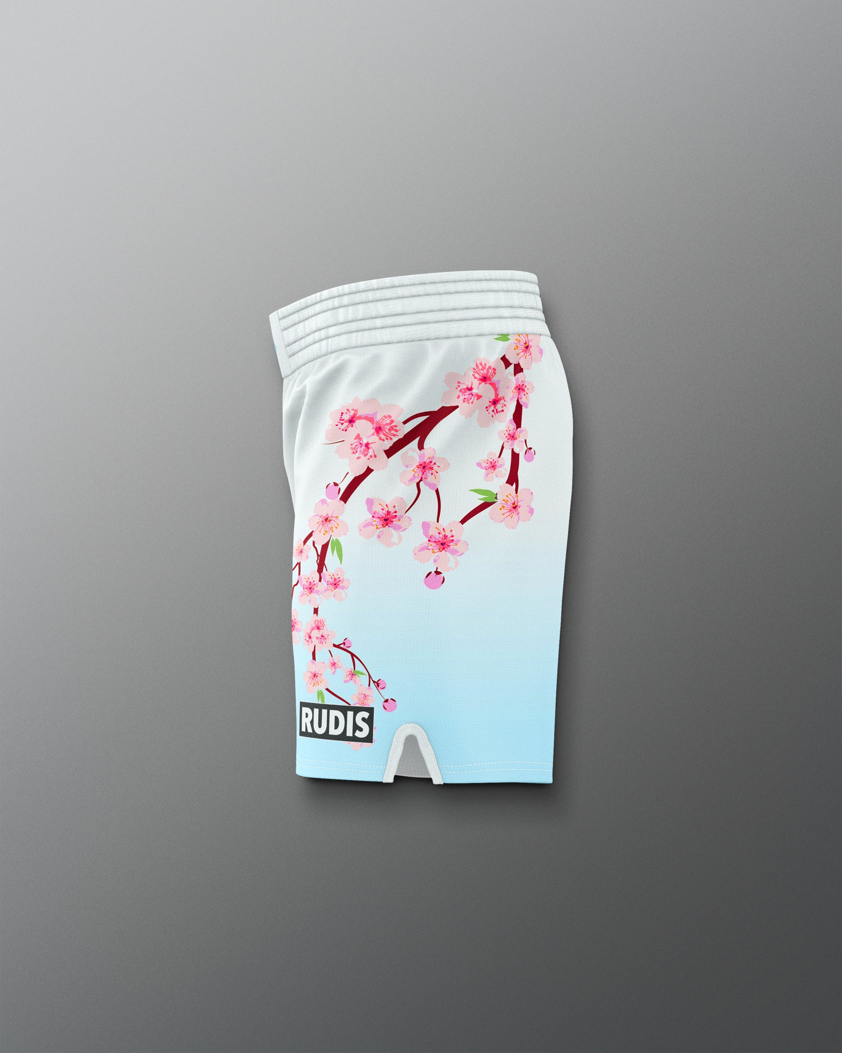 White shorts with cherry blossom design on a gray background