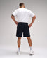 Person wearing a white t-shirt and black shorts on a gray background