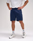 Person wearing navy shorts, white shirt, and white sneakers on a plain background