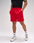 Person wearing red shorts and white sneakers on a plain background