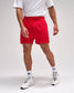 Person wearing red shorts, white t-shirt, and white sneakers on a plain background