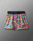 Colorful camouflage athletic shorts with 'Rudis Wrestling' logo on a gray background