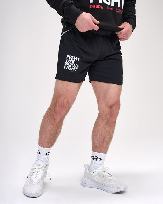 Person wearing black shorts with 'Fight the Good Fight' text, white sneakers, and socks on a white background.