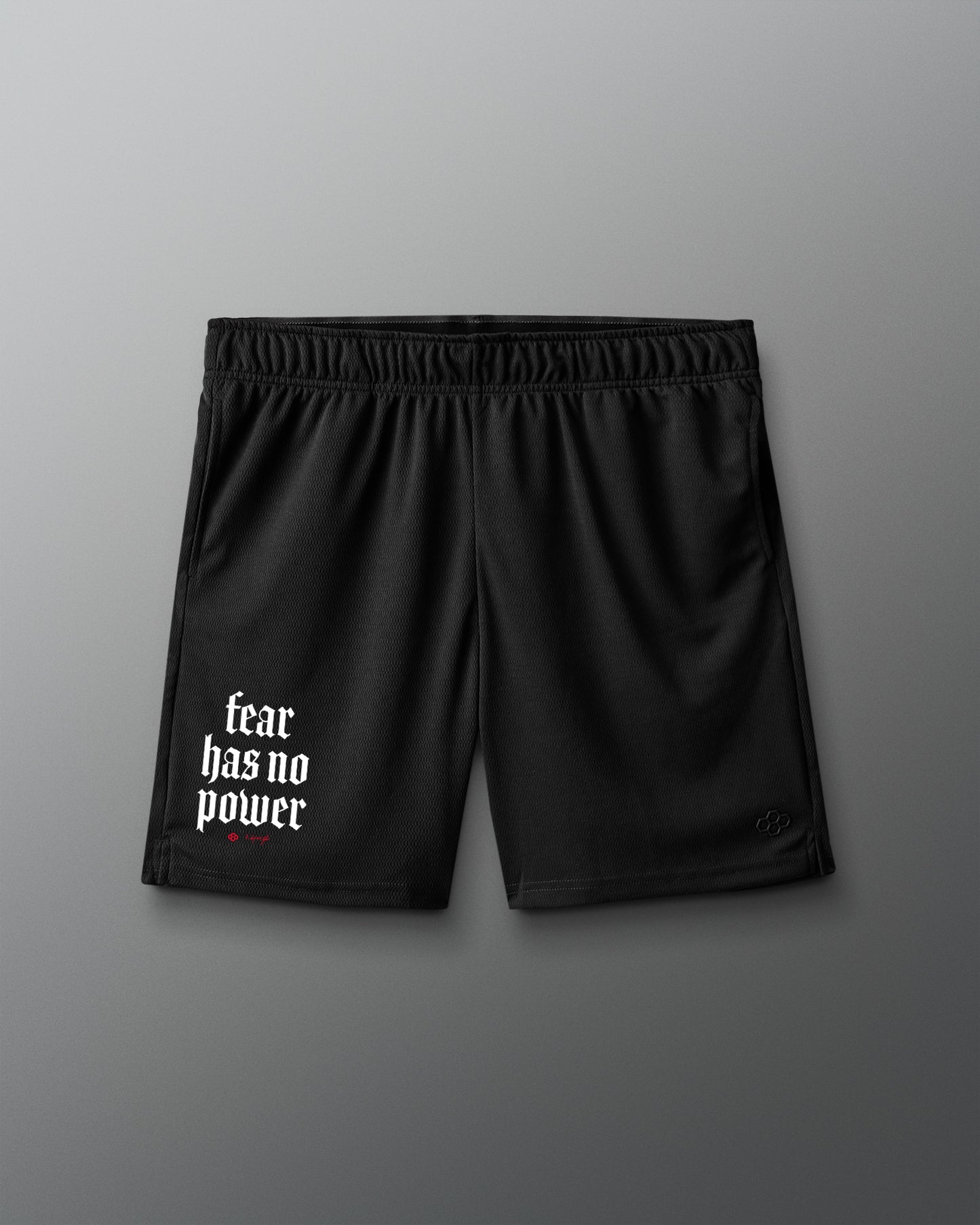 Black shorts with 'fear has no power' text on a gray background