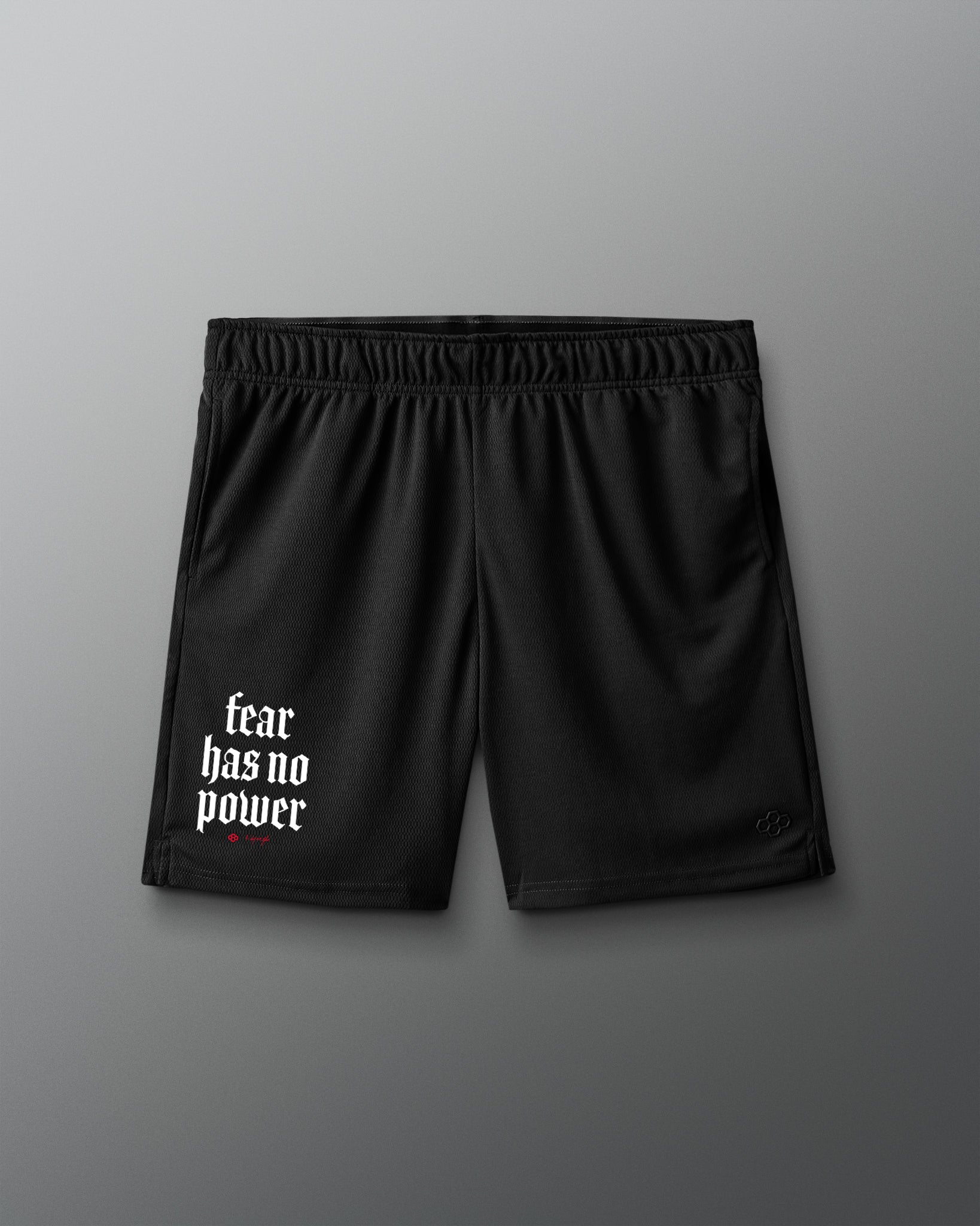 Black shorts with 'fear has no power' text on a gray background