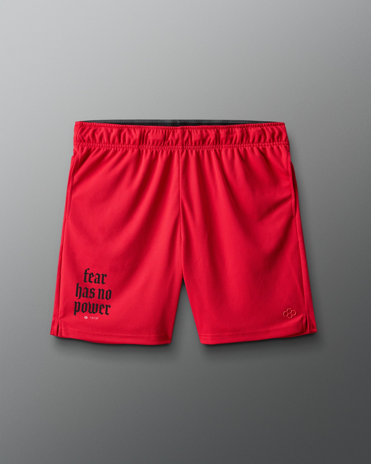 Red shorts with 'fear has no power' text on a gray background