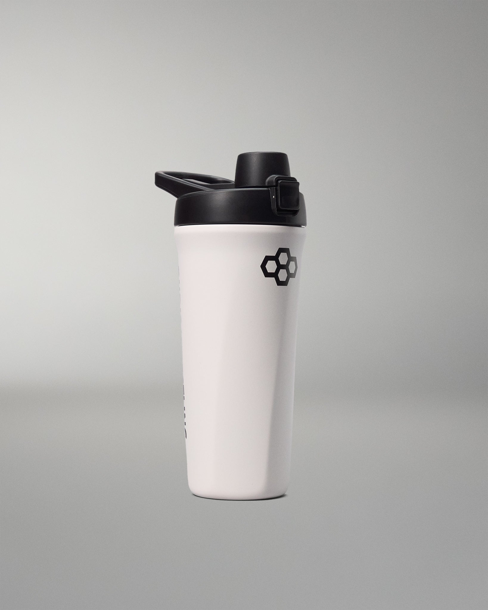 White shaker bottle with black lid on a gray background
