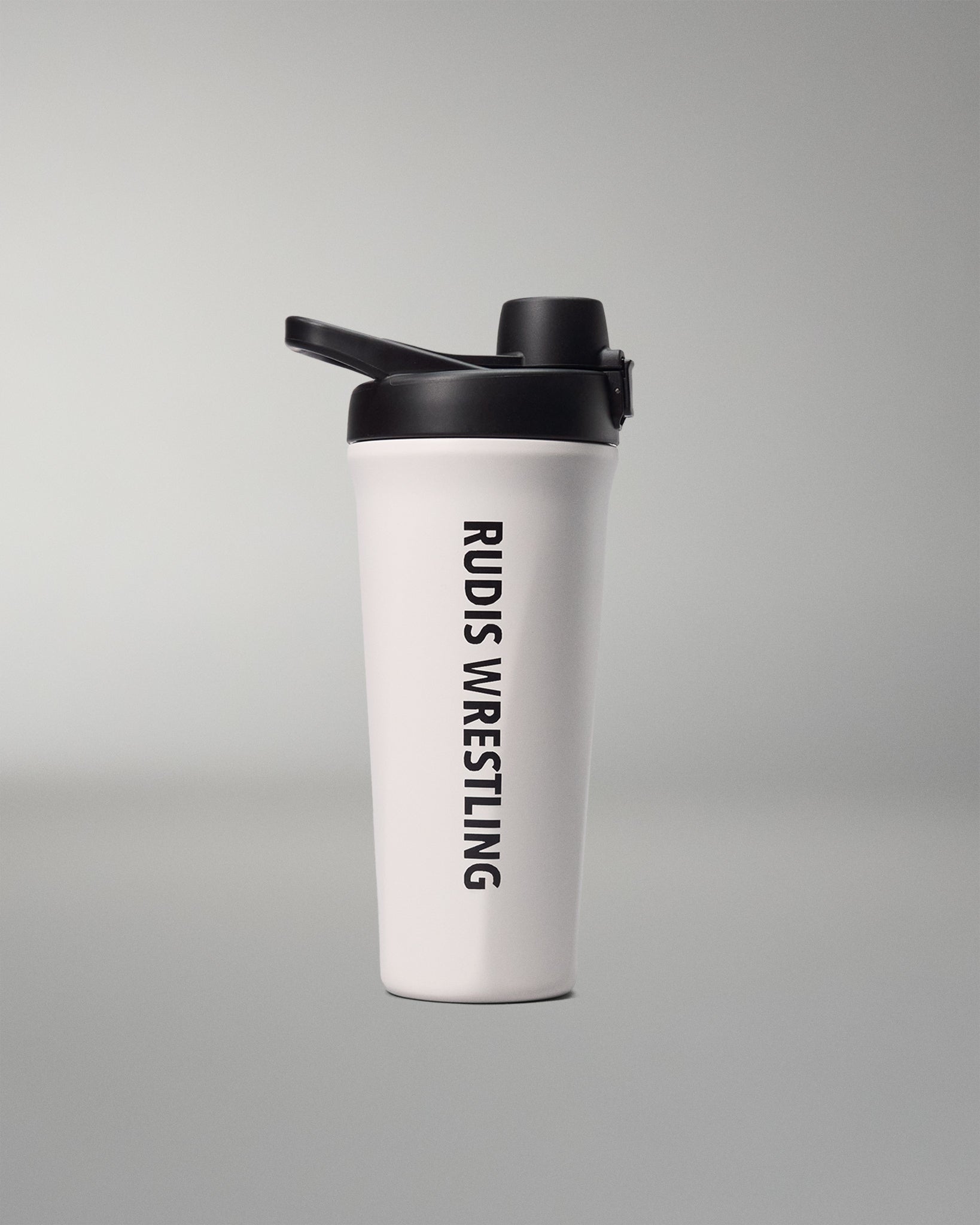 White shaker bottle with black lid and 'RUDIS WRESTLING' text on a gray background