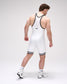 Person wearing a white wrestling singlet with black accents on a plain background