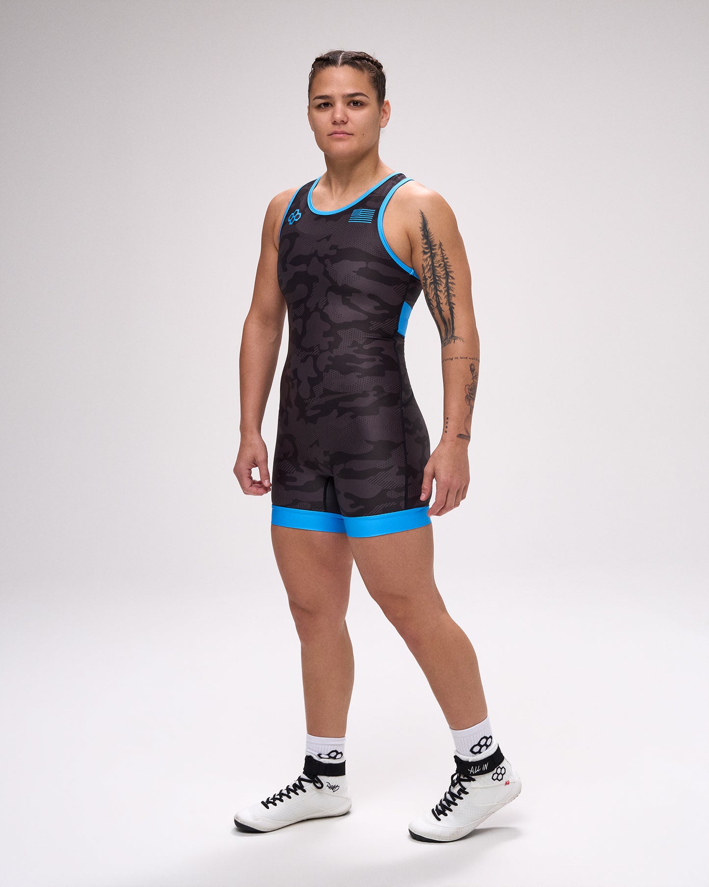 Person wearing a black and blue wrestling singlet on a white background