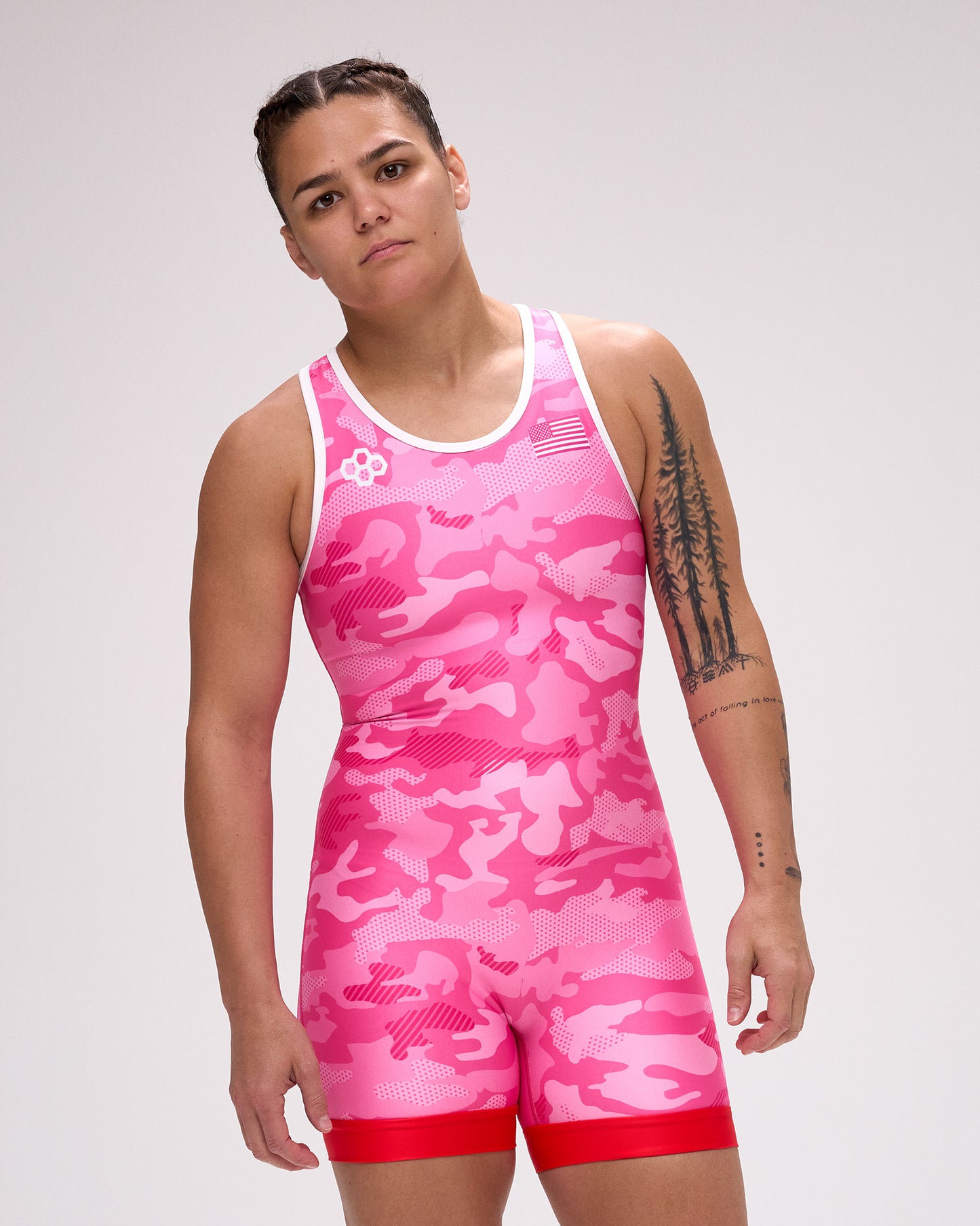 Person wearing a pink camouflage wrestling singlet on a gray background