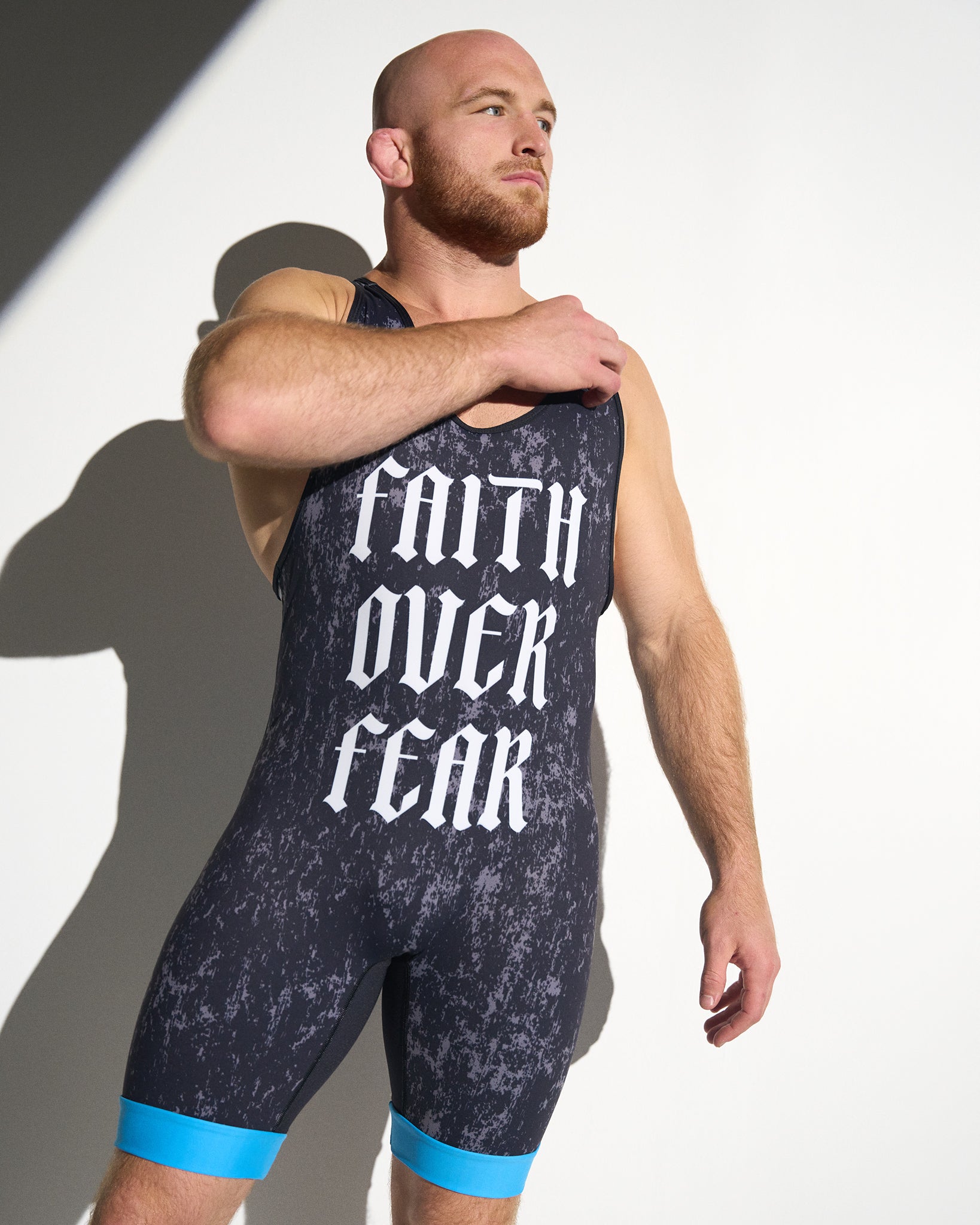 Close-up of the RUDIS Faith Over Fear Freestyle Elite 2.0 Wrestling Singlet in blue, highlighting the bold gothic "Faith Over Fear" front graphic and lightweight performance fabric.