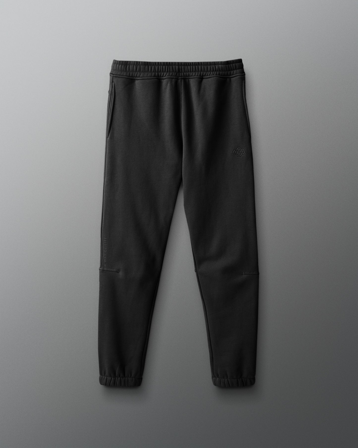 Black jogger pants on a gray background