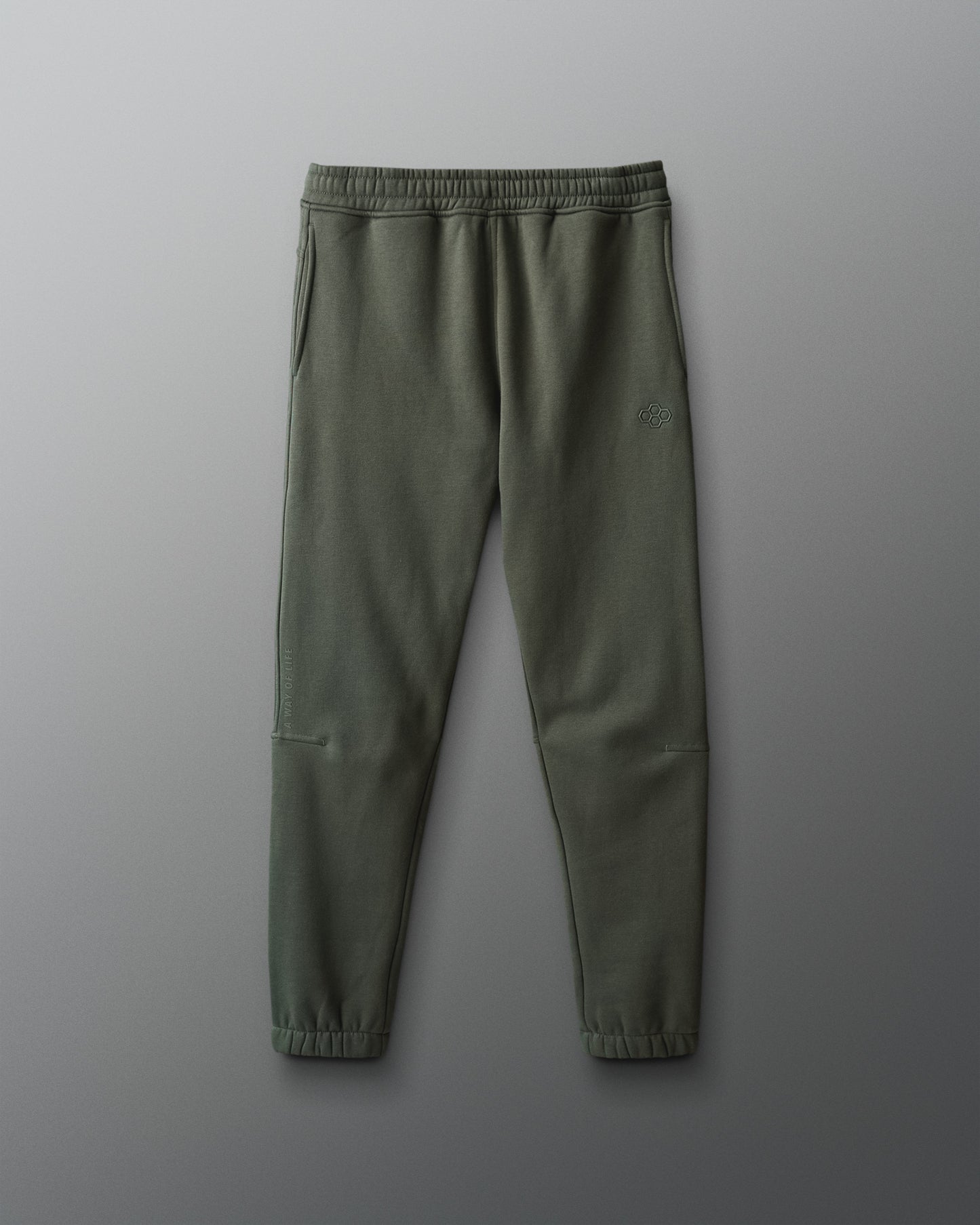 Green sweatpants on a gray background