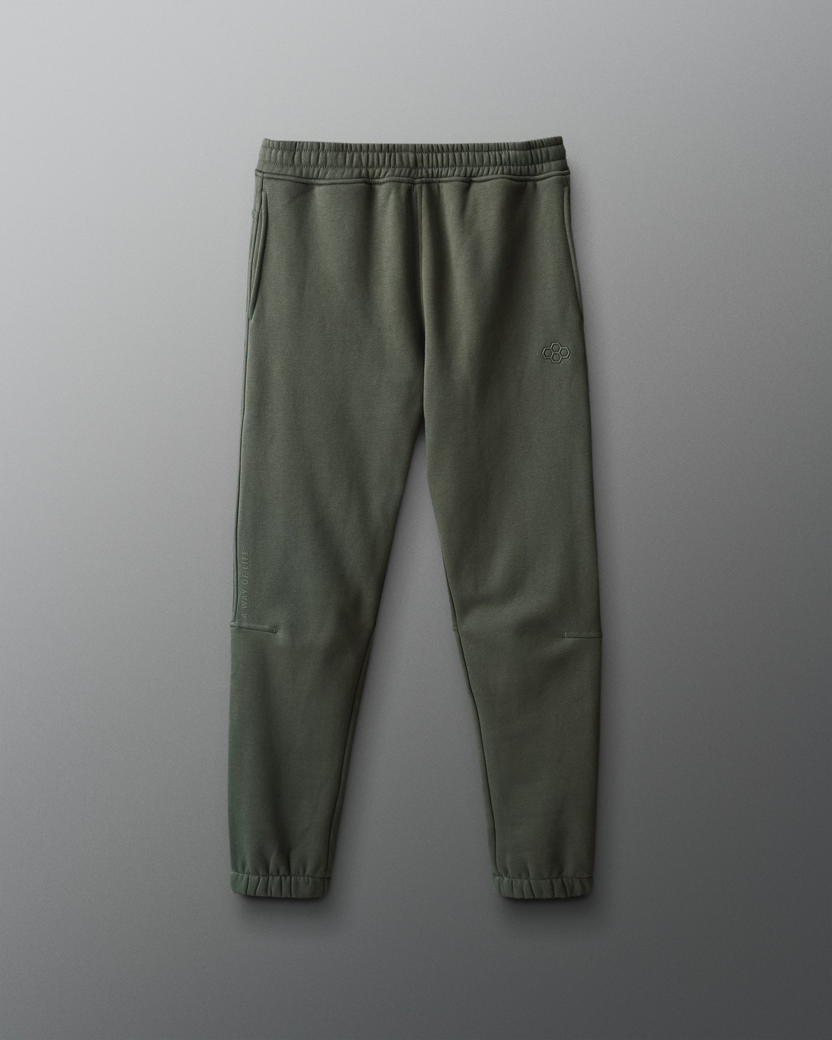 Green sweatpants on a gray background