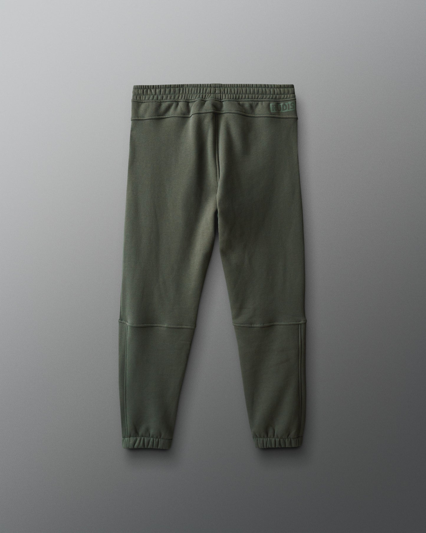 Green jogger pants on a gray background