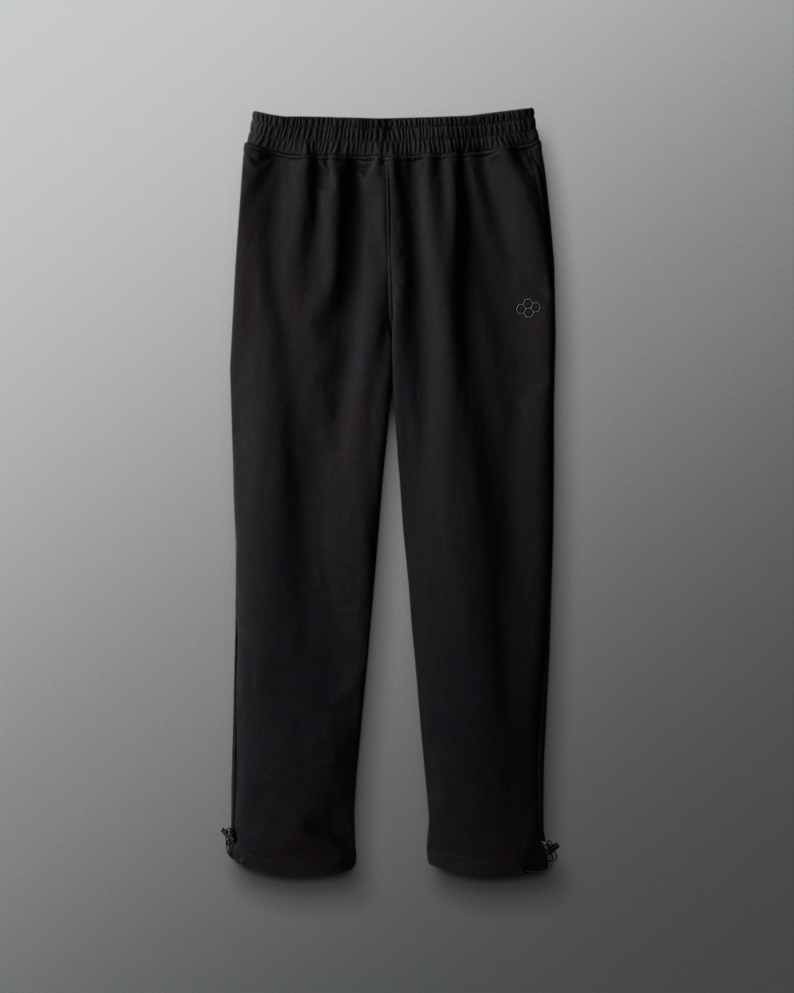 Black pants with a logo on a gray background