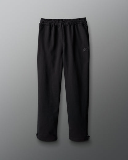 Black pants with a logo on a gray background