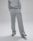 Person wearing a gray tracksuit on a light gray background