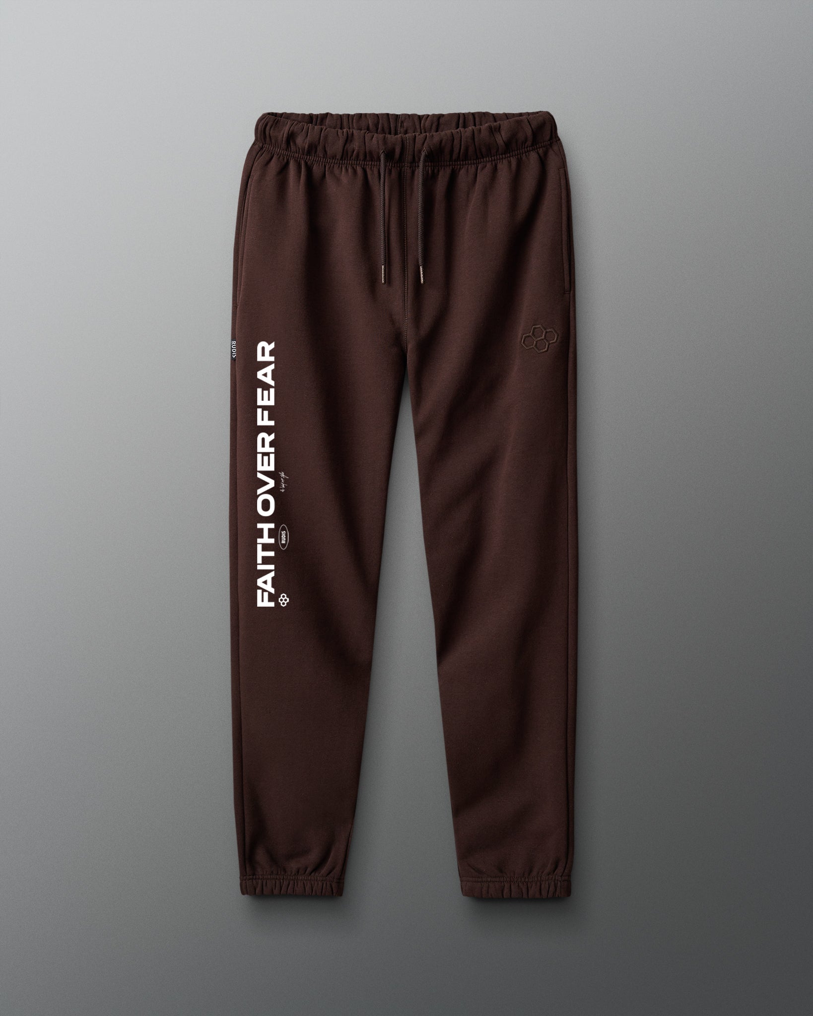 Brown sweatpants with 'Fath over Fear' text on a gray background
