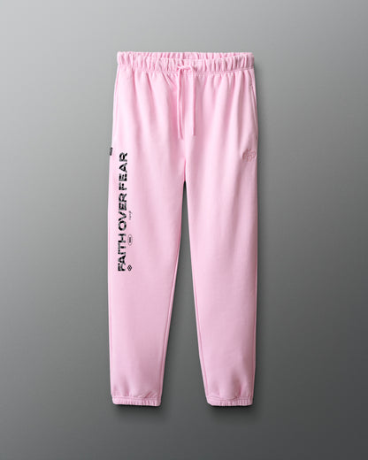 Pink sweatpants with 'Faith over fear' text on a gray background