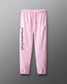 Pink sweatpants with 'Faith over fear' text on a gray background