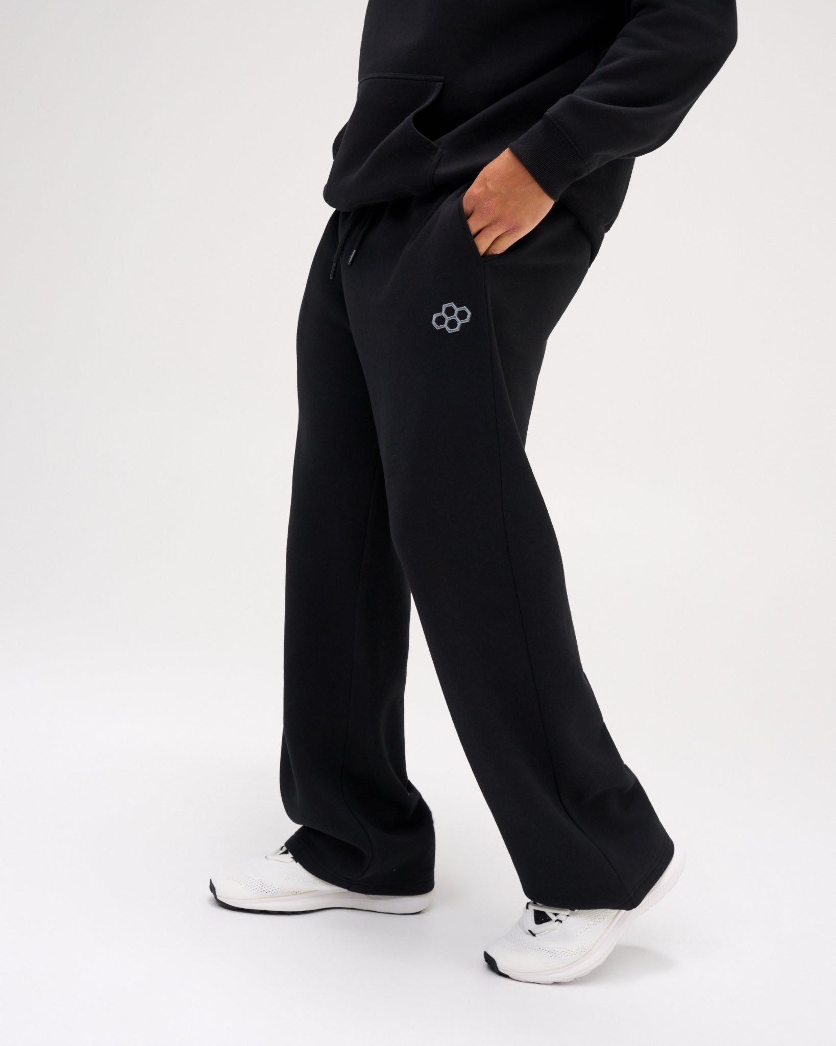 Side view of RUDIS Comfort Fleece Wide Leg Sweatpants in Black, featuring a relaxed wide-leg silhouette, side pockets, drawstring waistband and RUDIS logo.