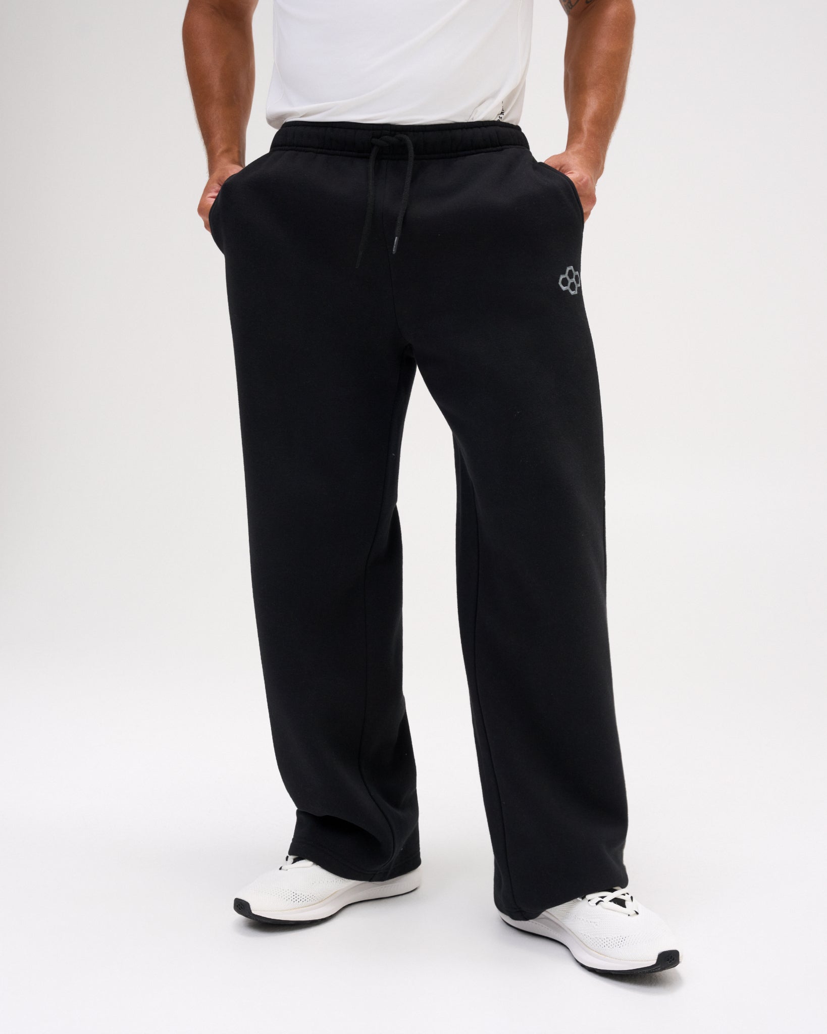 Front view of men's RUDIS Comfort Fleece Wide Leg Sweatpants in Black, highlighting the wide-leg cut, elastic drawstring waistband, side pockets and RUDIS logo. Copy Alt Text