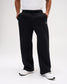Front view of men's RUDIS Comfort Fleece Wide Leg Sweatpants in Black, highlighting the wide-leg cut, elastic drawstring waistband, side pockets and RUDIS logo. Copy Alt Text