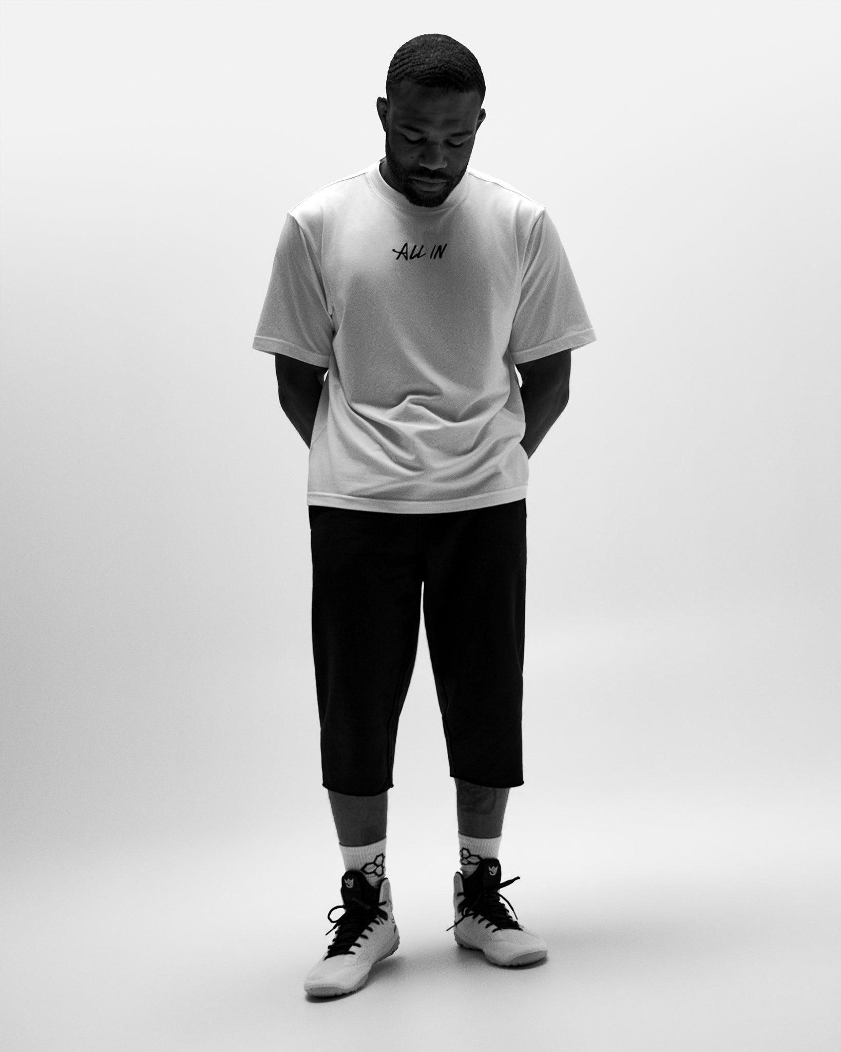 RUDIS Titan Heavyweight Cut Off Sweatpants in black worn with a white All In T-shirt and wrestling shoes.