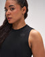 Woman wearing a black sleeveless top with a logo on a white background