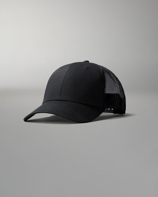 Black cap with mesh back on a gray background